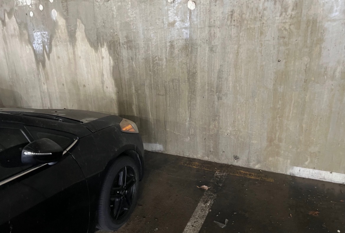 Dirty commercial concrete wall before pressure washing